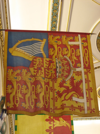 Red, gold and blue banner bearing the coat of arms of the Prince of Wales