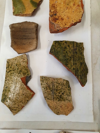 Photographs showing shards of glazed tiles.